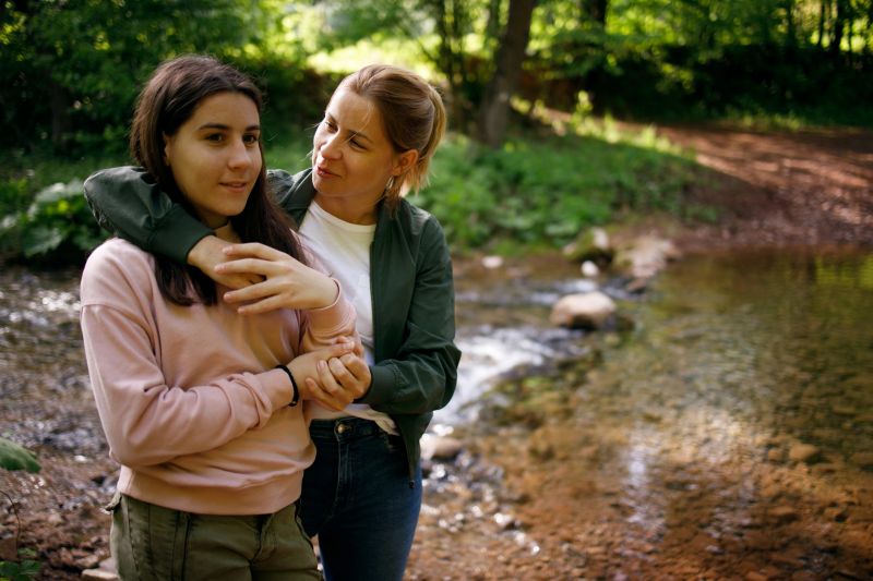 A mother and daughter are spending time together in nature.