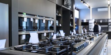 Modern kitchen appliance display with stoves and ovens.