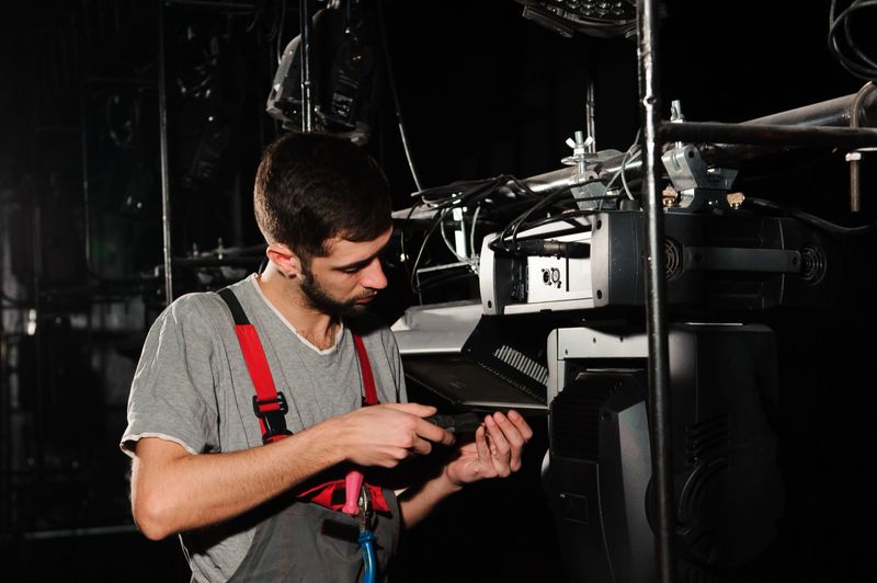 The lighting engineer adjusts the lights on the stage.