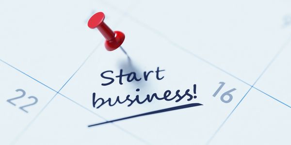Calendar marked with a red pin on 'Start business!' note.