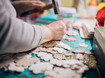 A group of women engaged in a pottery painting workshop.