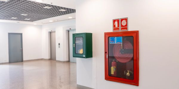 Fire safety equipment in a clean hallway.