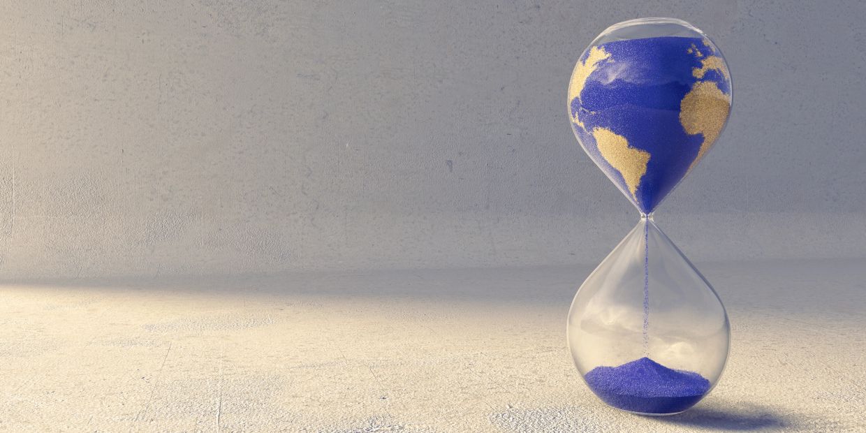Hourglass with a globe design made of sand.
