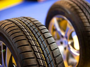 Close-up of two car tires with tread patterns.