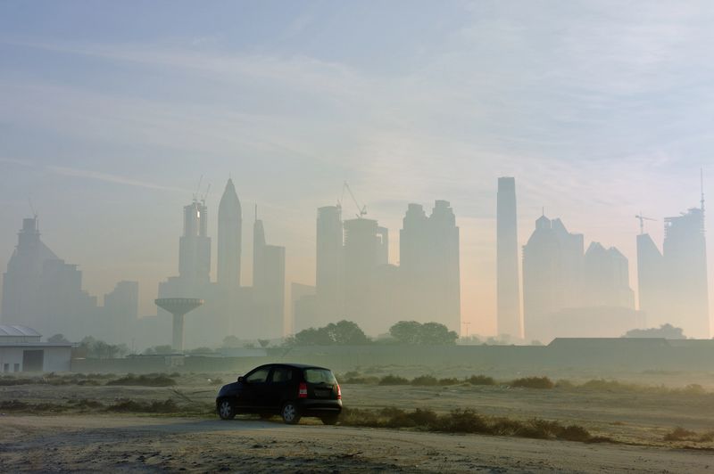 dubai central district as seen in the early morning from nearby dirt road. 