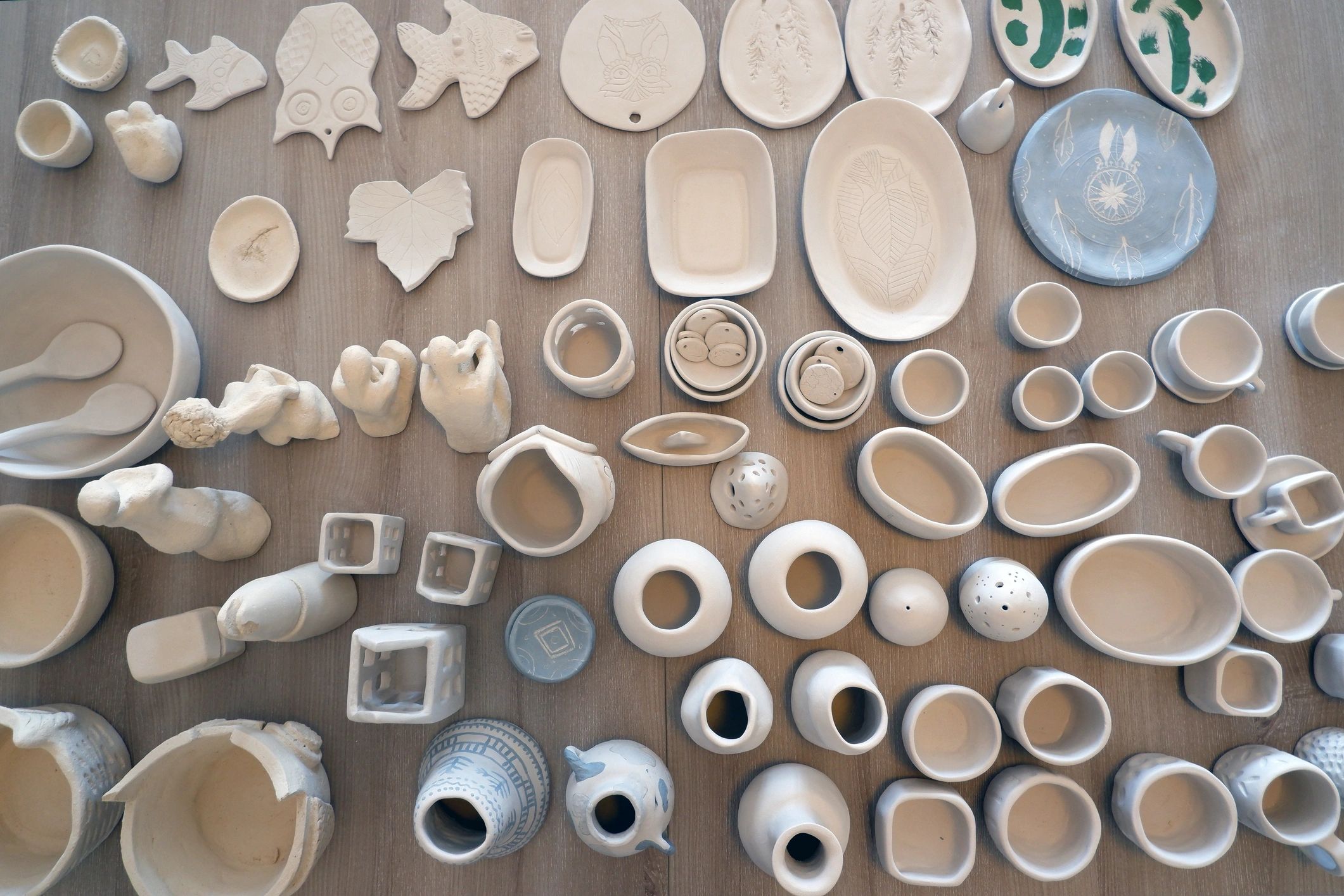Array of handmade ceramic pieces including dishes and small sculptures.