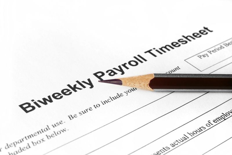 Close up of pencil on biweekly payroll time sheet