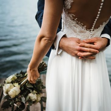 Bridal gown with flower bouquet. 