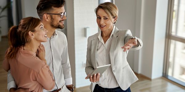 Real estate agent showing a couple a property.