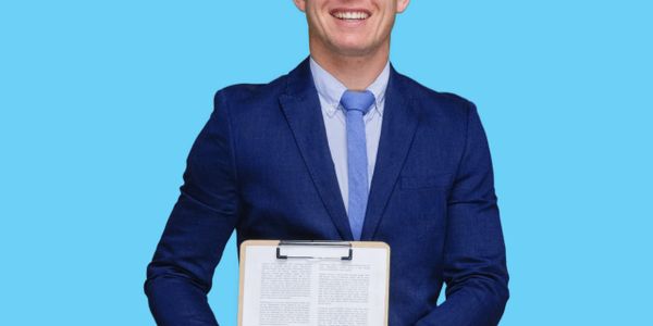 Smiling man in blue suit holds clipboard with document against blue background.