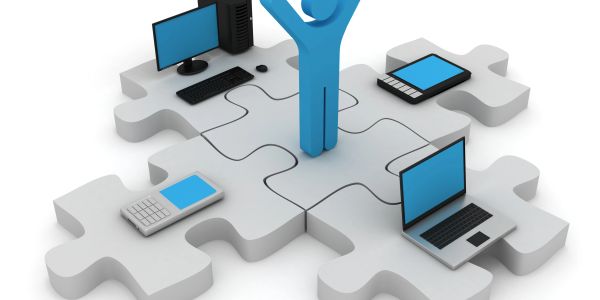 3D figure surrounded by digital devices on puzzle pieces.