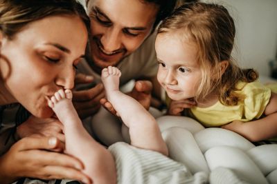 Family playing with baby feet.