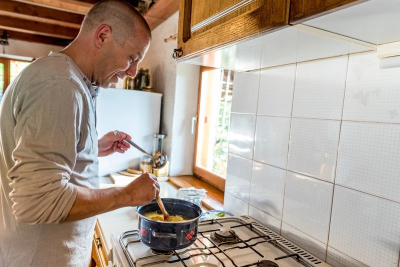 Man in Domestic Kitchen Waiting for a Perfect Melted Butter to Make Ghee