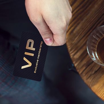 Hand holding a VIP exclusive membership card.