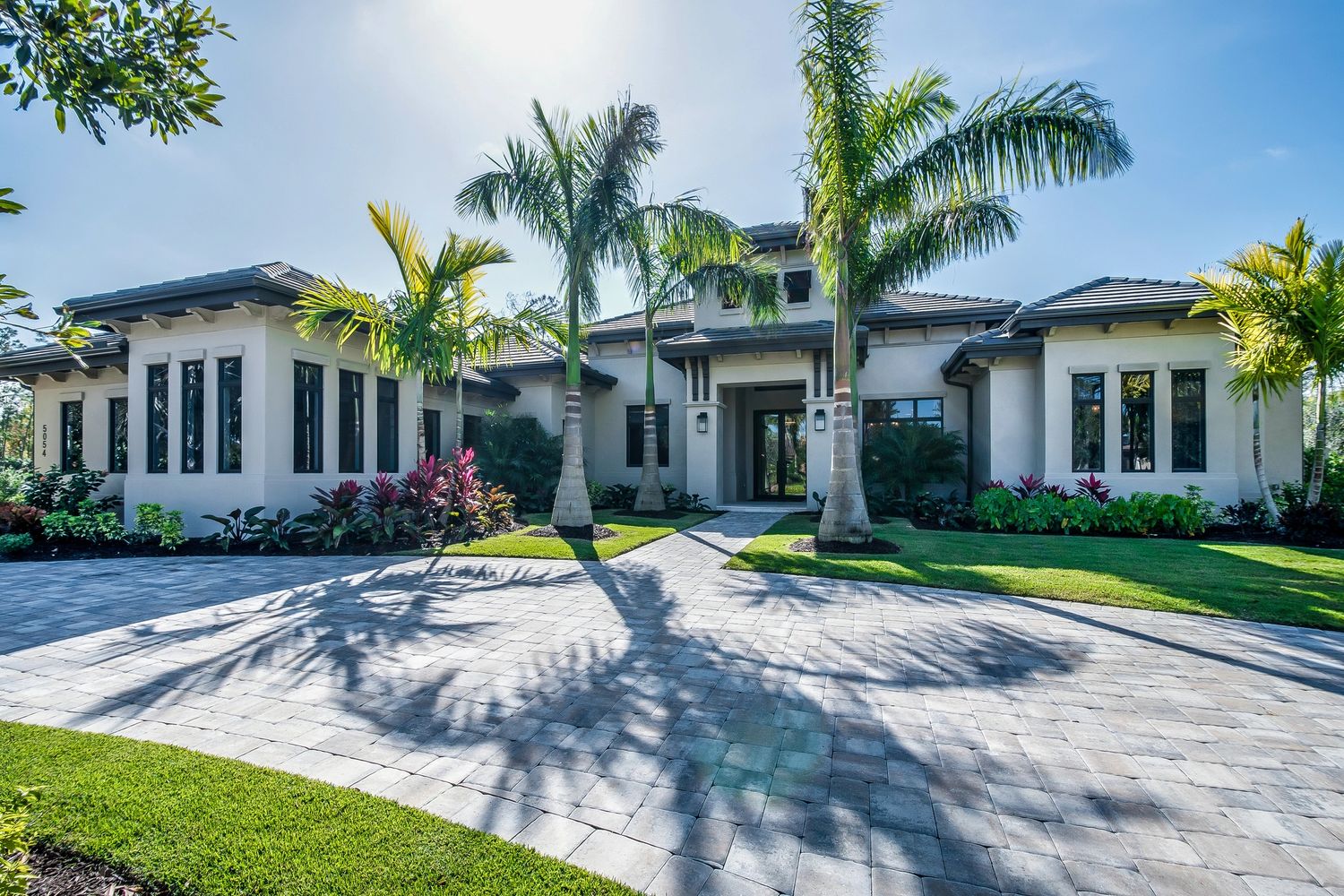 Professional house painter in Cape Coral applying high-quality Sherwin-Williams paint to exterior .