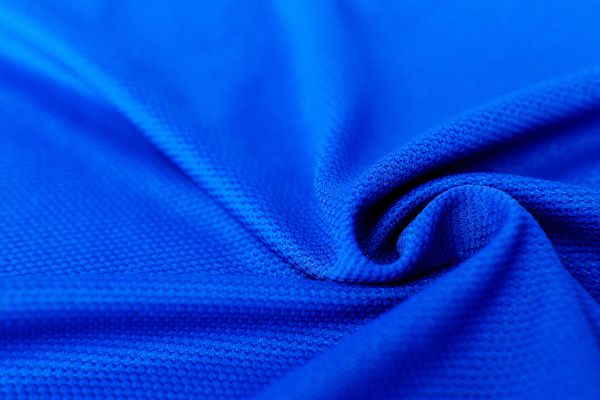 Close-up of blue textured fabric with folds.