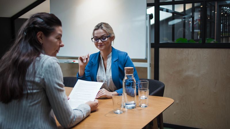 young HR woman interviews a candidate for a job. recruiter does a job interview and talks about the resume.