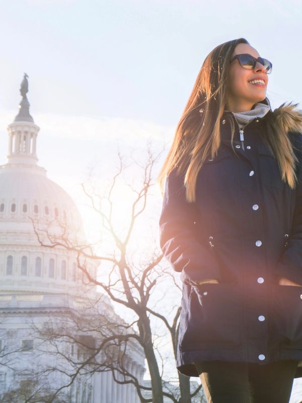 Woman near the U.S. Capitol dome in Washington DC, center for federal conferences and events.