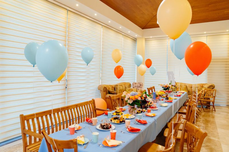 the festive table at a summer children's party in a country house. decoration balloons. catering.