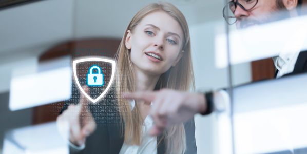 Two professionals discussing cybersecurity with a digital lock symbol.