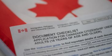 Canadian citizenship application checklist with a blurred maple leaf flag background.