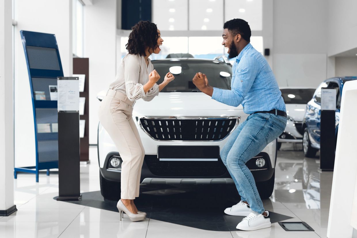 Happy couple buying a new car