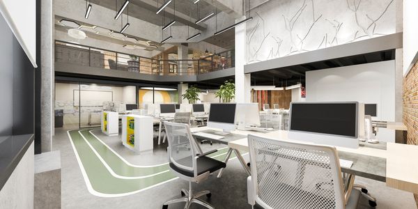Spacious modern office with high ceilings and sleek workstations.