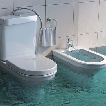 A bathroom with a flooded floor and running water from toilet and bidet.