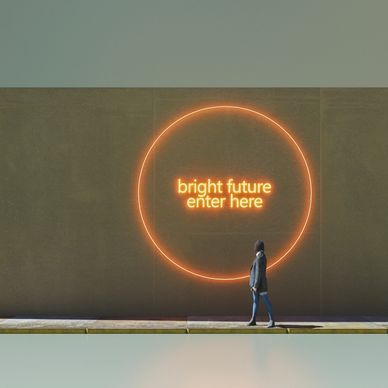 Person walks past neon sign saying 'bright future enter here'