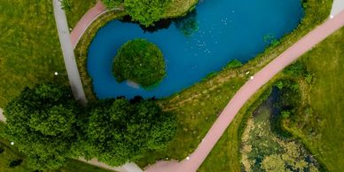 Aerial view of a park with two ponds and intersecting pathways.