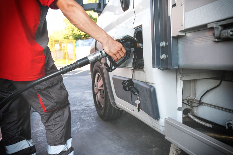 Hand refilling the car with fuel at the refuel station