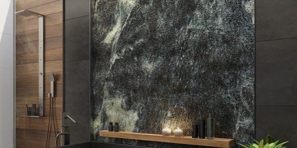 Modern bathroom with textured wall and black bathtub.
