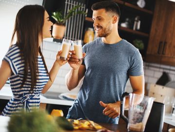 happy couple sharing drinks and feeling well with testosterone therapy and direct primary care 