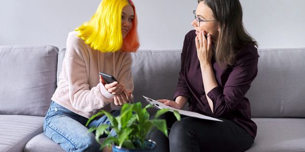 Teen receiving counselling from a youth therapist.
