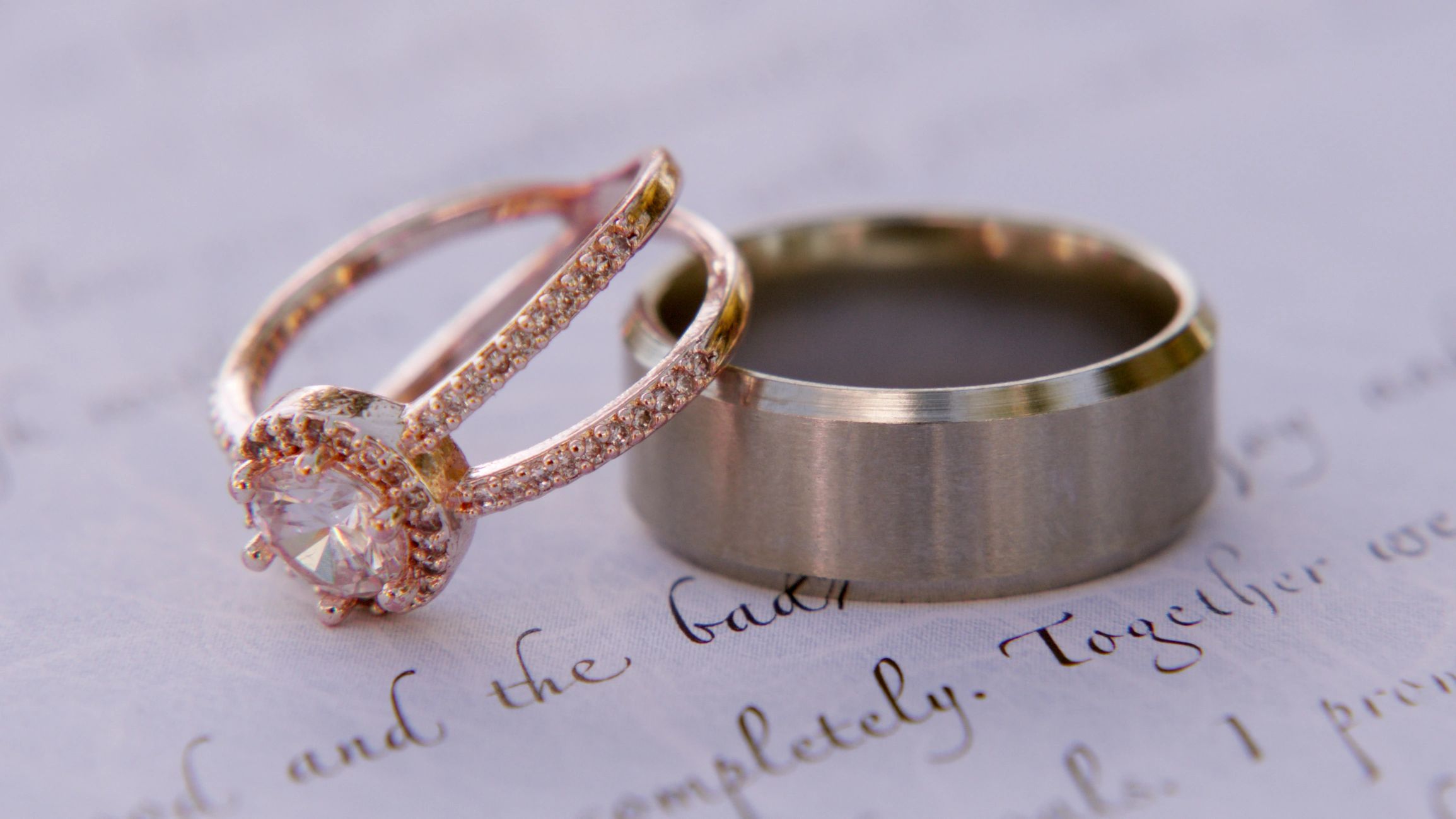 Close-up of two wedding rings on a handwritten note.