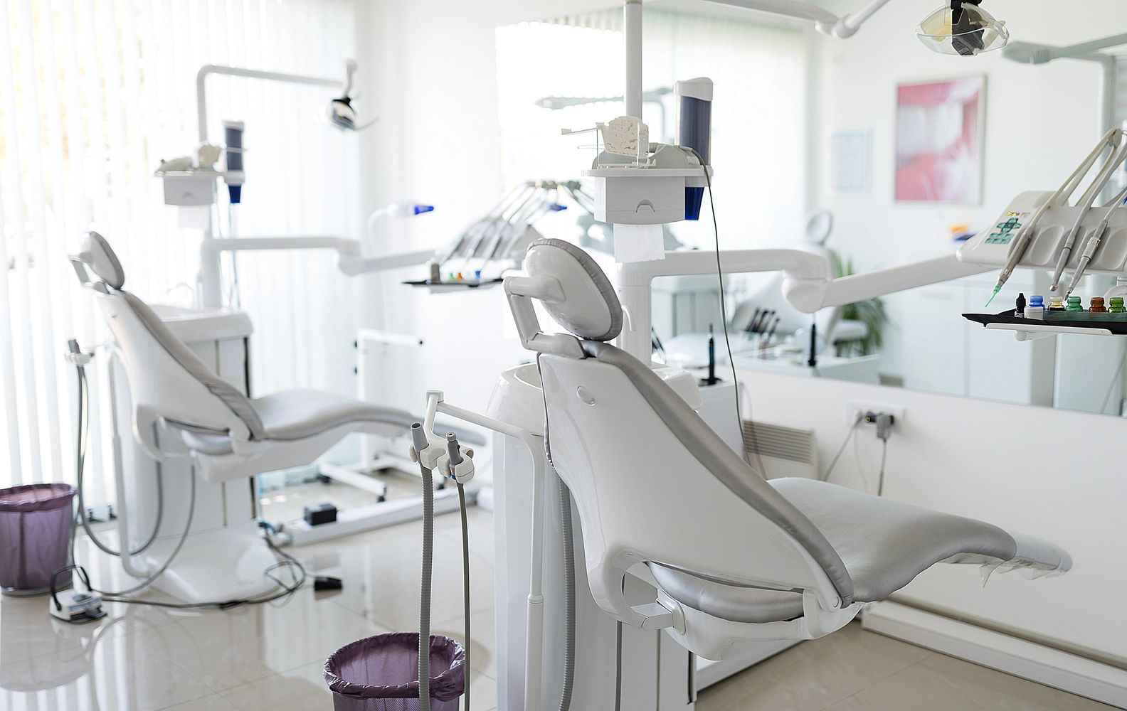 Modern dental office with clean, white dental chairs and equipment.