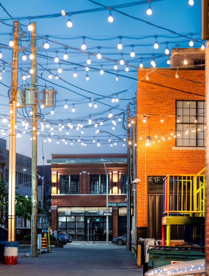 An illuminated city alley at night.