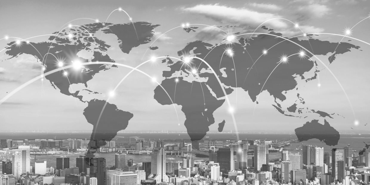World map with connected global network over a cityscape.