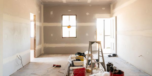 Empty room under renovation with construction materials.