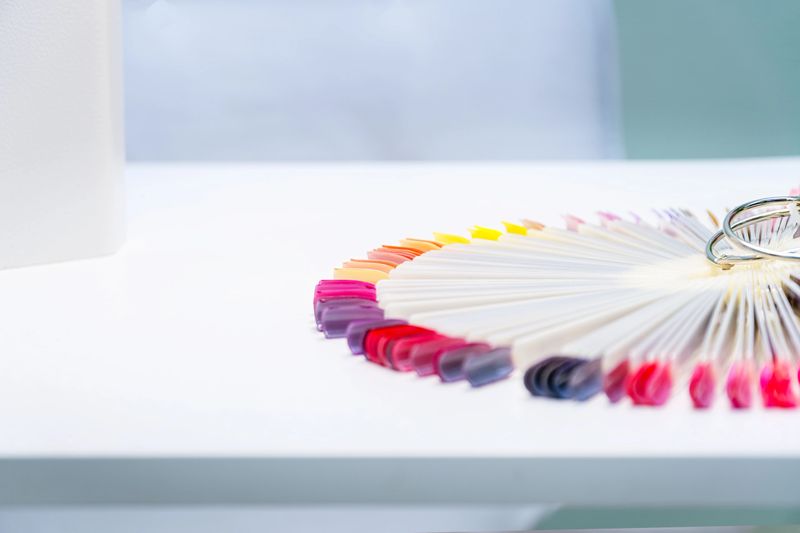 Multi-colored samples of nail tips for nail design on a light background