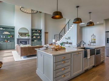 Modern open kitchen and living area with stylish island and cozy seating.