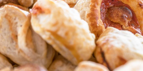 Close-up of assorted freshly baked pastries with golden crusts.