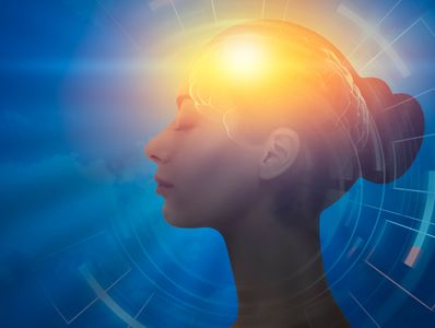Profile of a woman with glowing brain symbolizing intellect.