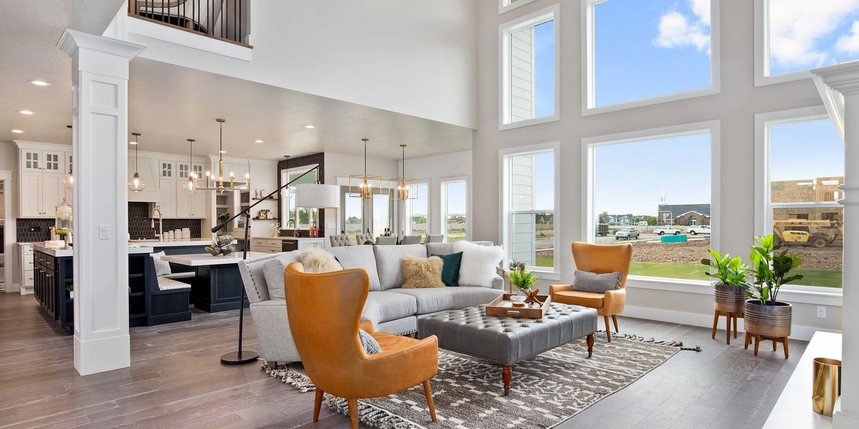 Bright modern living room with large windows and stylish furniture.