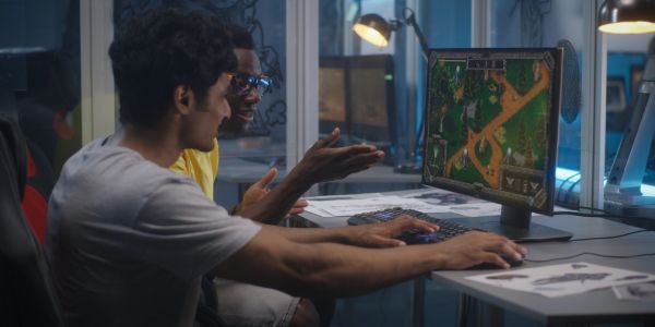 Two men playing a video game on a computer.