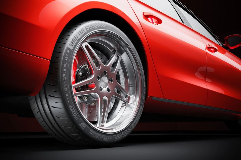 Wheel of red sports car closeup in studio lighting 3d render