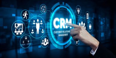 Hand interacting with digital CRM interface and business icons.