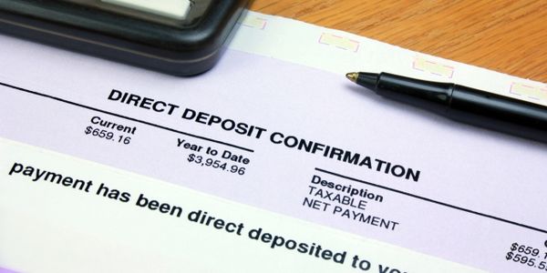 Direct deposit confirmation form with a calculator and a pen