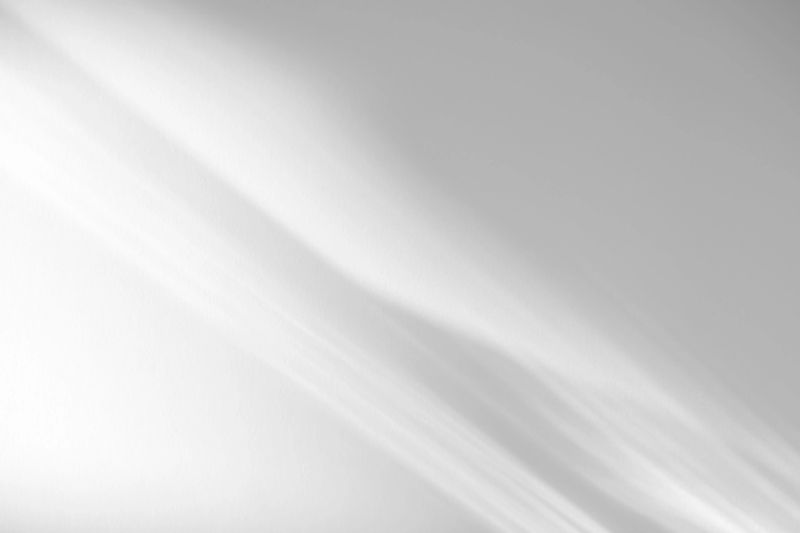 Blurred overlay effect for photo and mockups. Wall texture with organic drop diagonal shadow and rays of light on a white wall. shadows for natural light effects