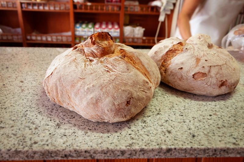 Two bagel bread over baker table with blurred woman unknown baker background